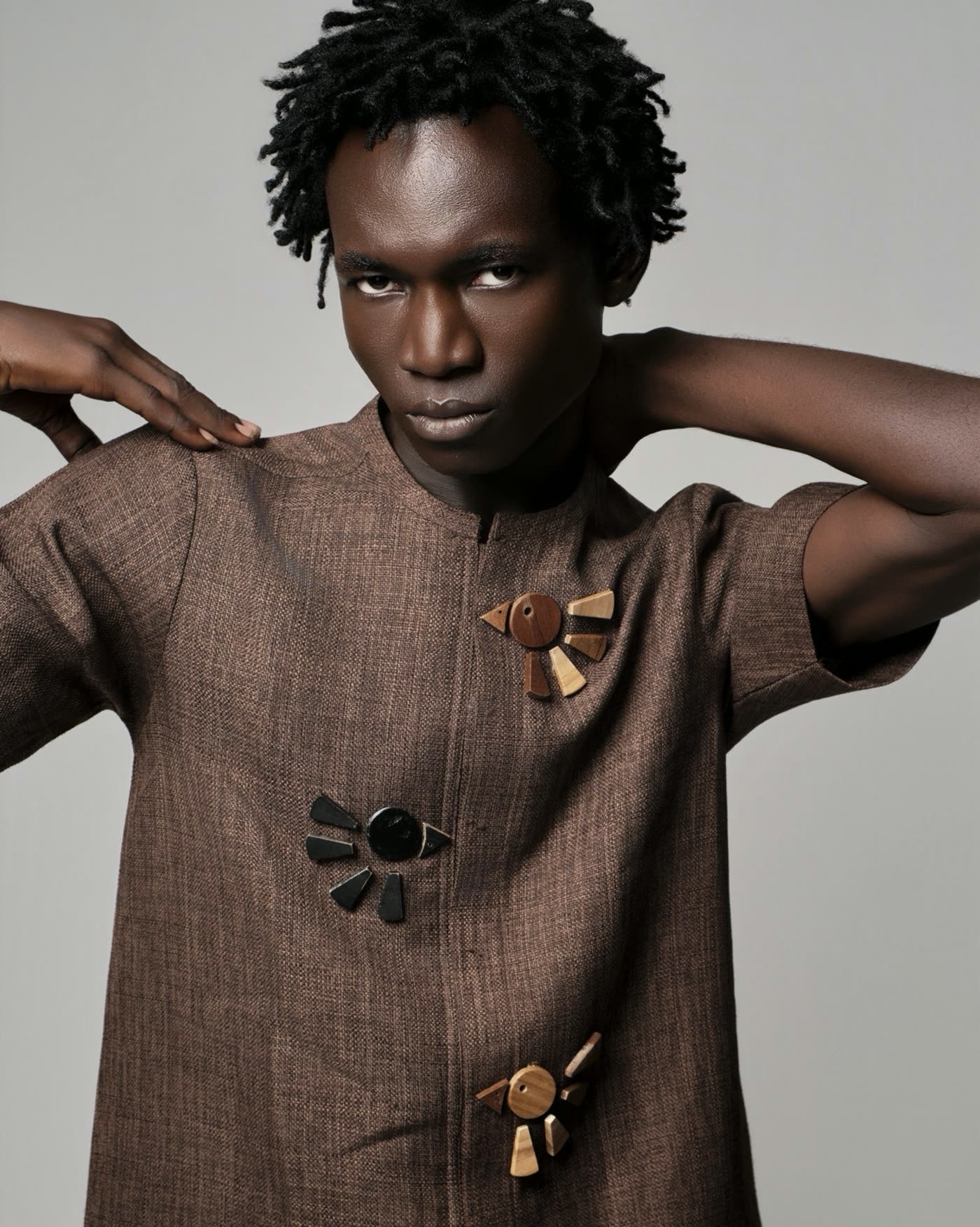 Ankyem look, textured brown tunic with hand carved wooden button motifs, Phyll Quahsey